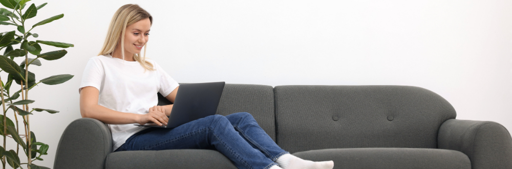 woman sitting on couch using a computer